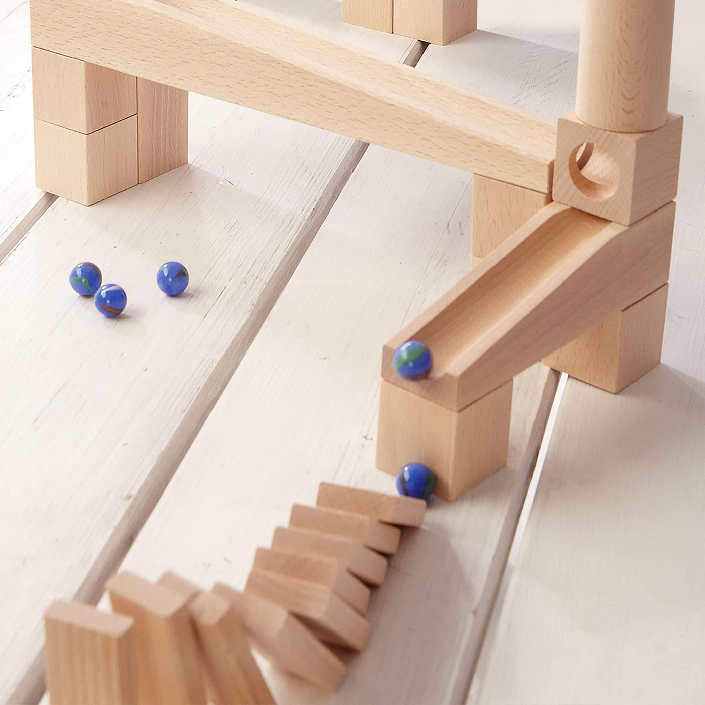 HABA Marble Run Wooden Ball Track Set with blue marbles and dominoes